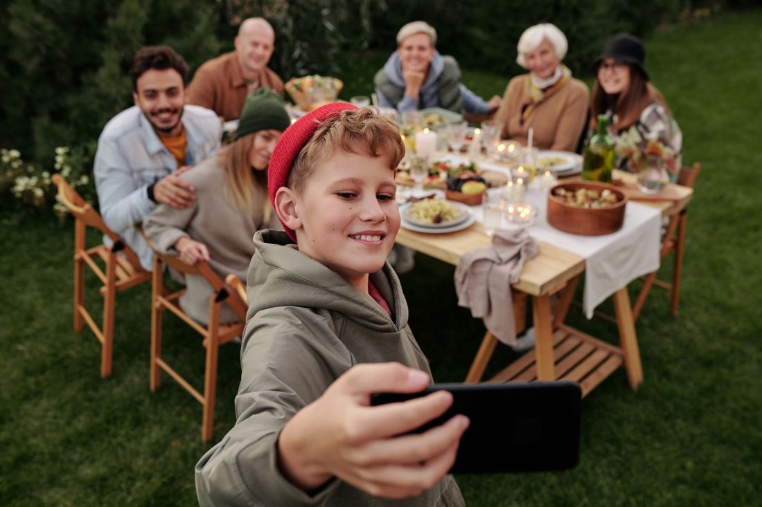 A grandmother laughing at a candlelit family dinner in the garden